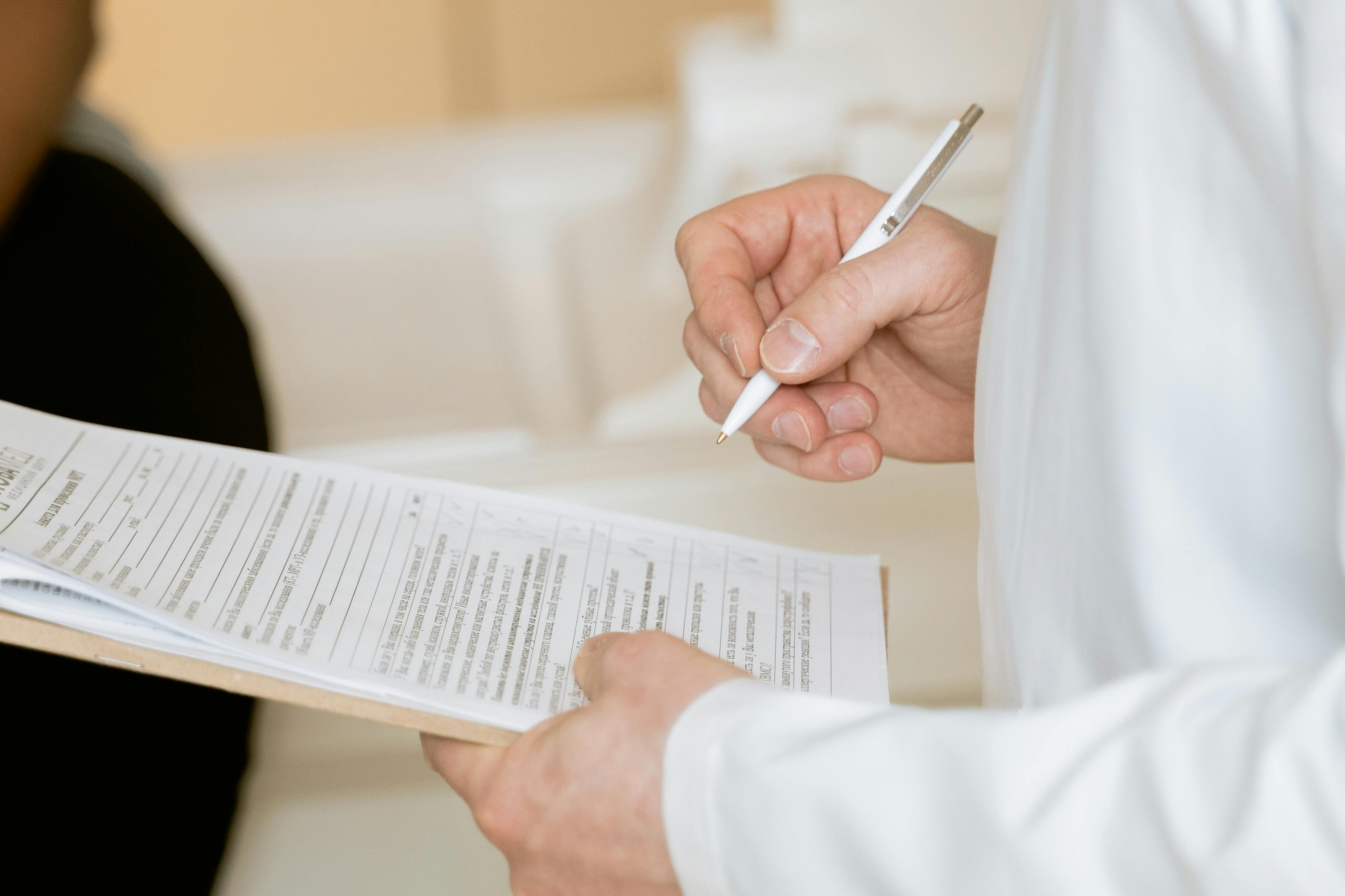 Doctor filling out patient form